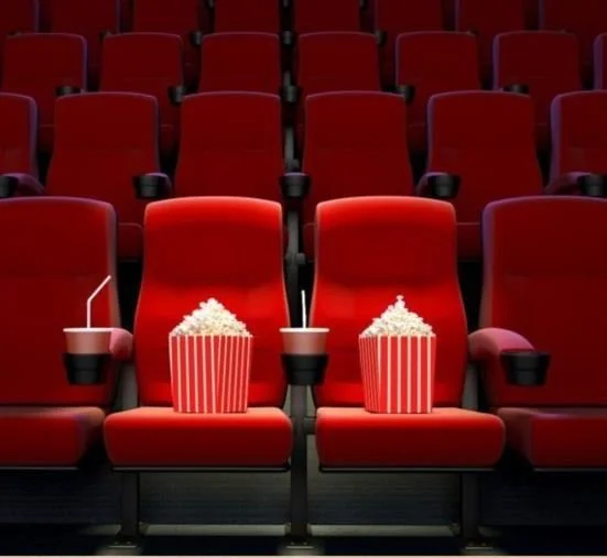 Empty cinema seats with popcorn and drinks