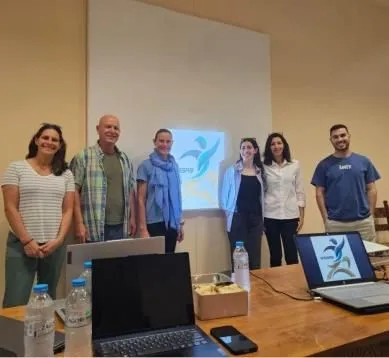 Partners standing in front of a presentation screen
