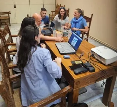 Partners working around a table with laptops